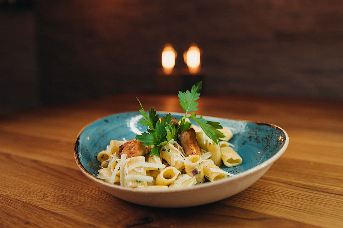 Carbonara di Salmone Penne mit frischem Lachs und roten Zwiebeln, in Ei-Sahnesauce, Petersilie und Grana Padano D.O.P.